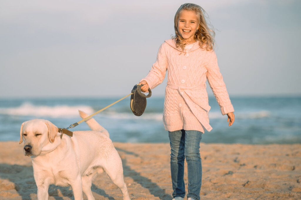 Little girl walking her dog